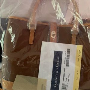 Beautiful Dooney and Bourke satchel Brown with Carmel trim. New with tags